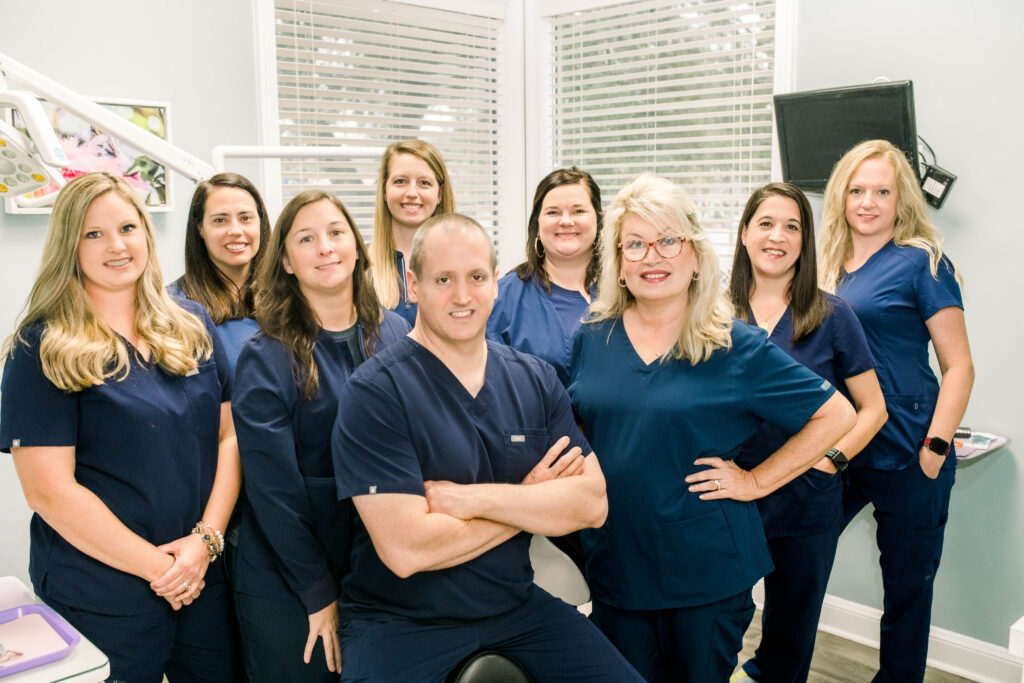 A group photo of dental professionals from Bozeman Dental smiling together.