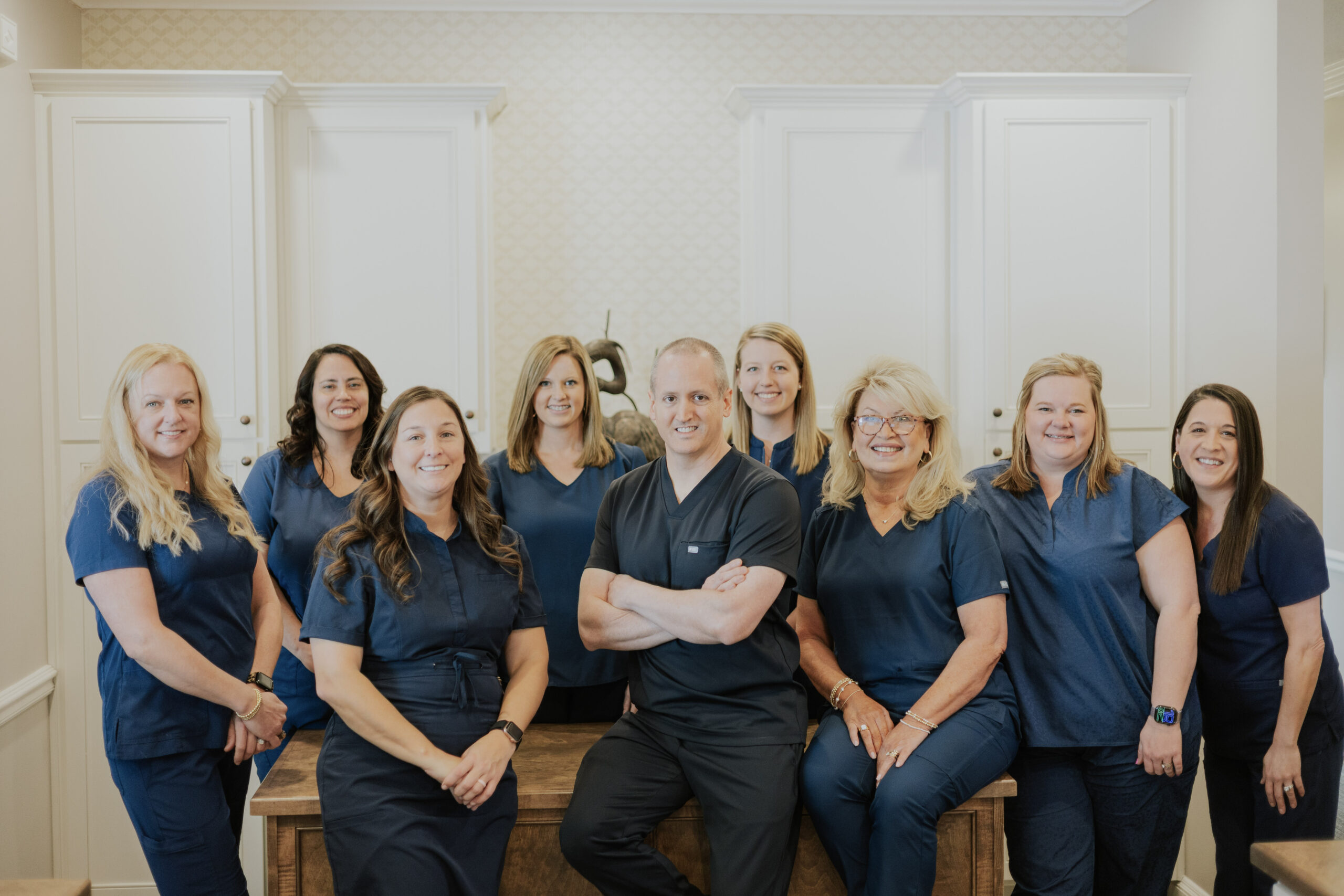 A group photo of dental professionals from Bozeman Dental smiling together.